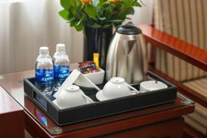 a tray with cups and water bottles on a table at A25 Premium Hotel - 705 Lac Long Quan in Hanoi