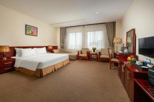 a hotel room with a bed and a television at A25 Premium Hotel - 705 Lac Long Quan in Hanoi