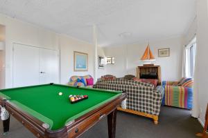 a living room with a pool table and couches at Mirimar in Apollo Bay