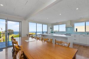 a kitchen and dining room with a table and chairs at Mirimar in Apollo Bay
