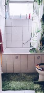 a bathroom with a tub and a toilet in it at Apartment to stay in Wernau