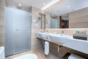 a bathroom with a sink, toilet and shower at The Landmark Bangkok - SHA Extra Plus in Bangkok