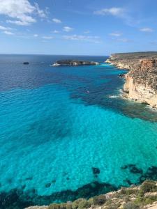 an aerial view of a beach with blue water at Pretty Damuso Style Villa in Lampedusa