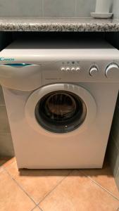 a white washing machine sitting under a counter at Casa Sofia vista porto in Olbia