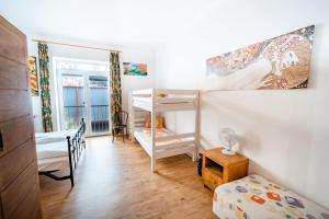 a bedroom with two bunk beds and a window at Club Canada Lipno De Luxe in Lipno nad Vltavou +52 photos