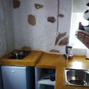 uma cozinha com um lavatório e uma bancada em Venduri House em Péran Triovasálos