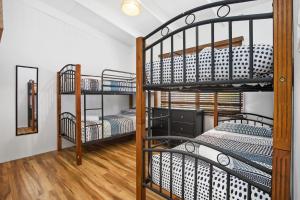 a room with three bunk beds and a mirror at Villa Zara in Marengo
