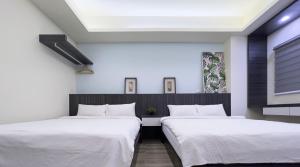 Ένα ή περισσότερα κρεβάτια σε δωμάτιο στο 攜蔚貳館包棟民宿