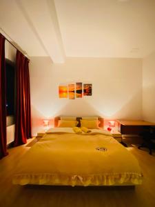 a bedroom with a large yellow bed and a desk at Gobi-Girl in Ulaanbaatar