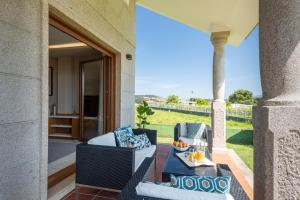 a patio with two chairs and a table at MA Maisons & Apartments Vista Alegre in Paxarinas
