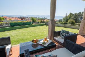 a patio with a table with a bowl of fruit on it at MA Maisons & Apartments Vista Alegre in Paxarinas