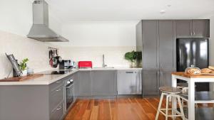a kitchen with gray cabinets and a counter top at Tree Scape Retreat in Robertson