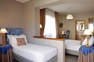 Voodi või voodid majutusasutuse BeYou Hotel Ponte Milvio toas
