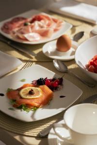 a table with plates of food on a table at La Residenza Capri in Capri