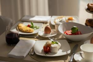 a table with plates of food and a bowl of vegetables at La Residenza Capri in Capri