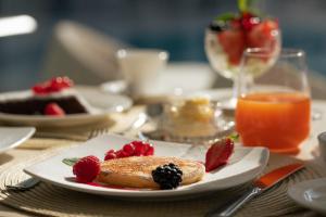 a plate of food with fruit on a table at La Residenza Capri in Capri