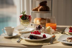 a table topped with a plate of cake and pastries at La Residenza Capri in Capri