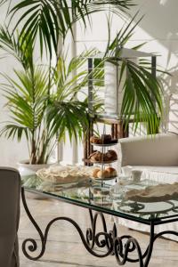 a glass table with a tray of donuts on it at La Residenza Capri in Capri