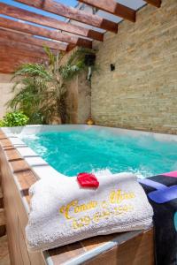 een zwembad met een handdoek erop bij Central Area Bedroom With Common Kitchen, living room in Sosúa