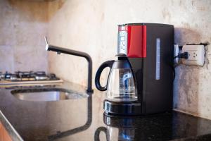 a coffee maker sitting on top of a counter at Room in Guest room - Cozy 1bd with common Jacuzzi in Sosúa