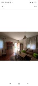 a living room with a couch and a table at Casa Villa El Olivar in Huelva
