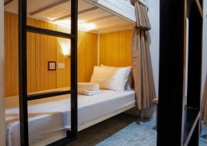 a bedroom with a bunk bed with a mirror at B&B Backpackers in Coron