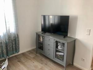 a flat screen tv sitting on top of a cabinet at Emmerglück Lügde in Lügde