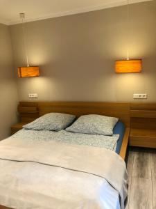 a bedroom with two beds and two lights on the wall at Emmerglück Lügde in Lügde
