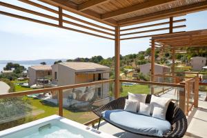 a view from the balcony of a house with a tub at ELIVI Skiathos in Koukounaries