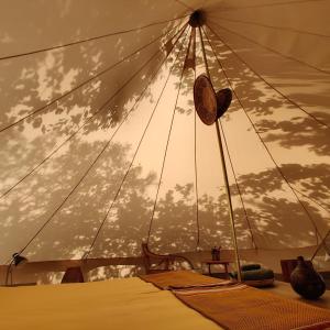 a bedroom with a canopy with clouds in the sky at Under Canvas Bornholm in Østermarie