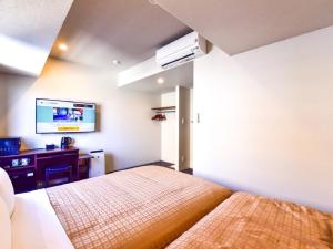 A bed or beds in a room at HOTEL LiVEMAX Hakata Nakasu