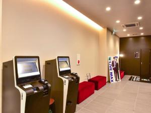 eine Lobby mit zwei Videospielautomaten in einem Zimmer in der Unterkunft HOTEL LiVEMAX Hakata Nakasu in Fukuoka