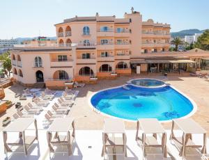a large swimming pool in front of a building at Rosamar Ibiza Hotel in San Antonio Bay