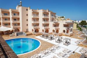 un'immagine di un hotel con piscina e sedie di Rosamar Ibiza Hotel a San Antonio