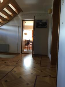 a hallway with a door open to a dining room at Tammehouse in Otepää