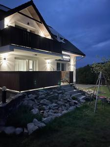 a house with a stone path in front of it at Apartamenty Na Szlaku in Iwonicz-Zdrój