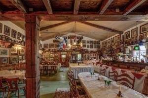 a restaurant with tables and chairs in a room at Pension Auf der Olk mit Röpertsmühle in Veldenz