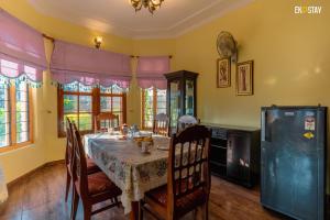 EKO STAY - Camden Villa في ناينيتال: غرفة طعام مع طاولة وكراسي