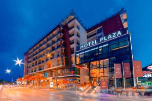 a hotel plaza with a building at night at Hotel TQ Plaza in Budva