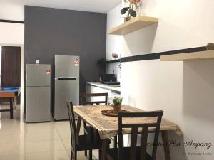 a kitchen with a table with chairs and a refrigerator at 4 bedrooms apartment Arte Plus KL in Kuala Lumpur