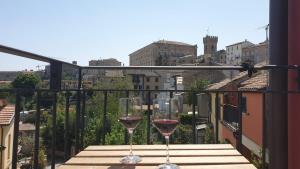 two glasses of wine sitting on a balcony at Italian Experience-Aghel Luxury Apartment in Recanati