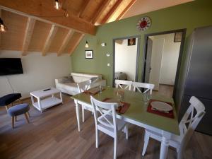 a living room with a table and chairs and a couch at Au Vert ! in Le Vert