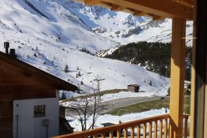 a view of a snow covered mountain from a house at Chalet Sternenhimmel in Arosa