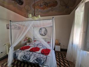 a bedroom with a bed with red roses on it at PalazzoRegina in Pergola