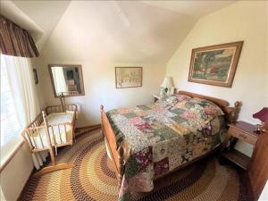 a bedroom with a bed and a table and a window at Palisades 2 - V017 in Lake Arrowhead