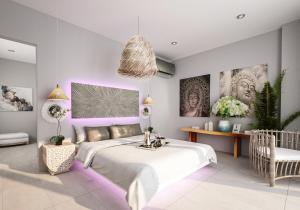 a bedroom with a large bed with purple lighting at BLACK AMBER BOUTIQUE HOTEL in Lampi