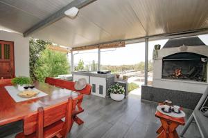 a living room with a table and a fireplace at Holiday House Roza in Vela Luka