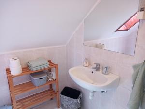 a white bathroom with a sink and a mirror at Borostyán Vendégház in Balatonkeresztúr +24 photos