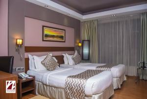 Voodi või voodid majutusasutuse Ngong Hills Hotel toas