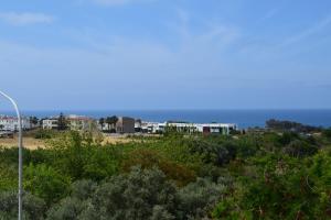 a view of a beach with buildings and the ocean at Eden Heights Sea View Apartment 203 - By IMH Travel & Tours in Paphos City